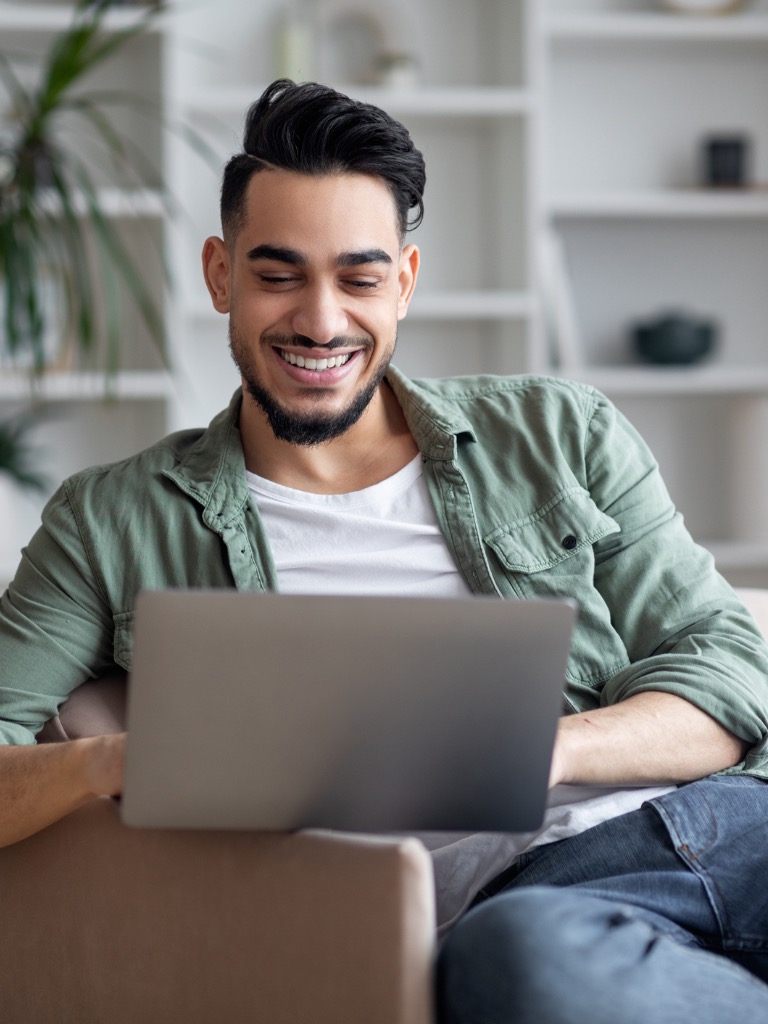 Man in front of a computer, renewing his car tag