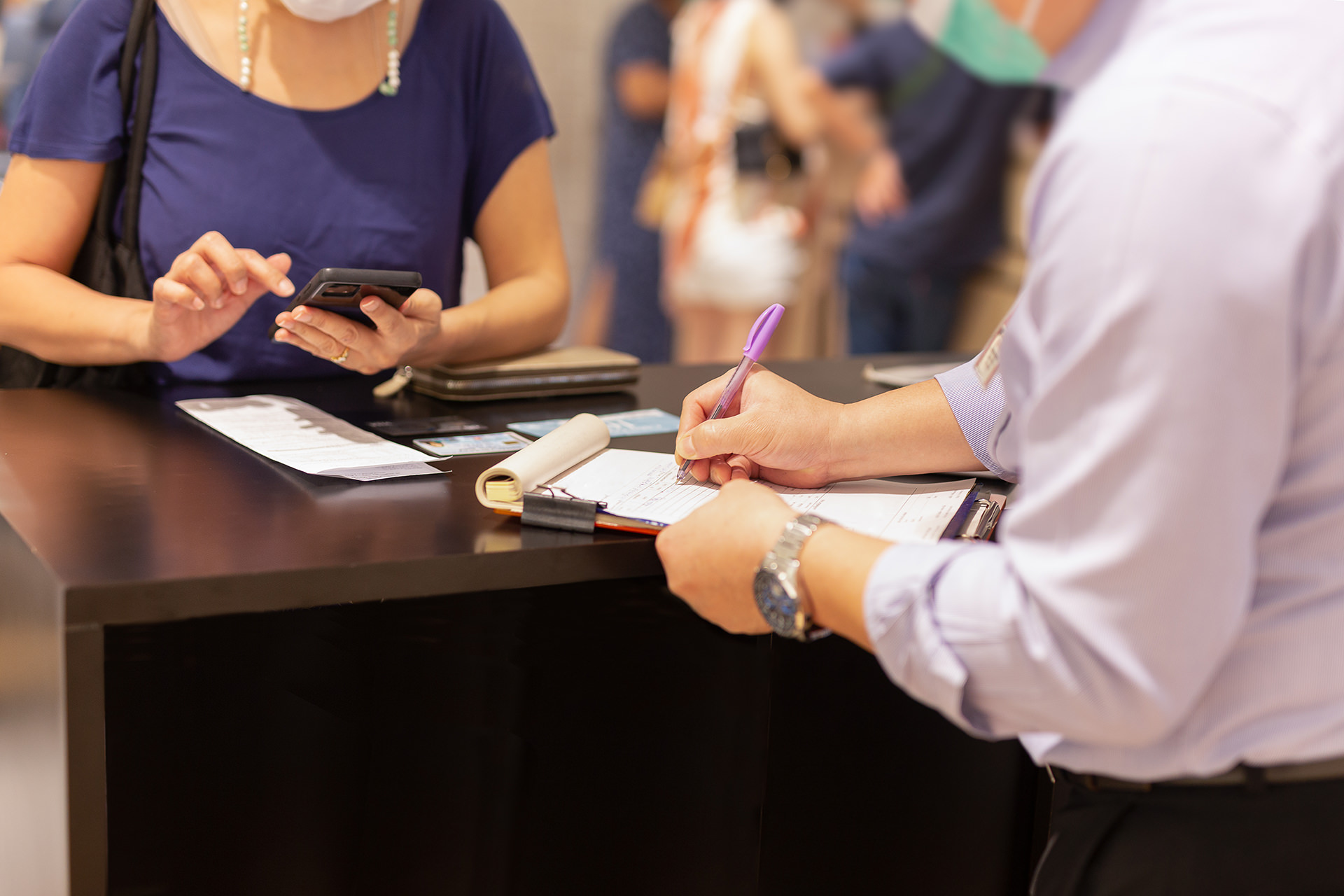 Oklahoma vehicle title transfer paperwork being reviewed at a tag agency