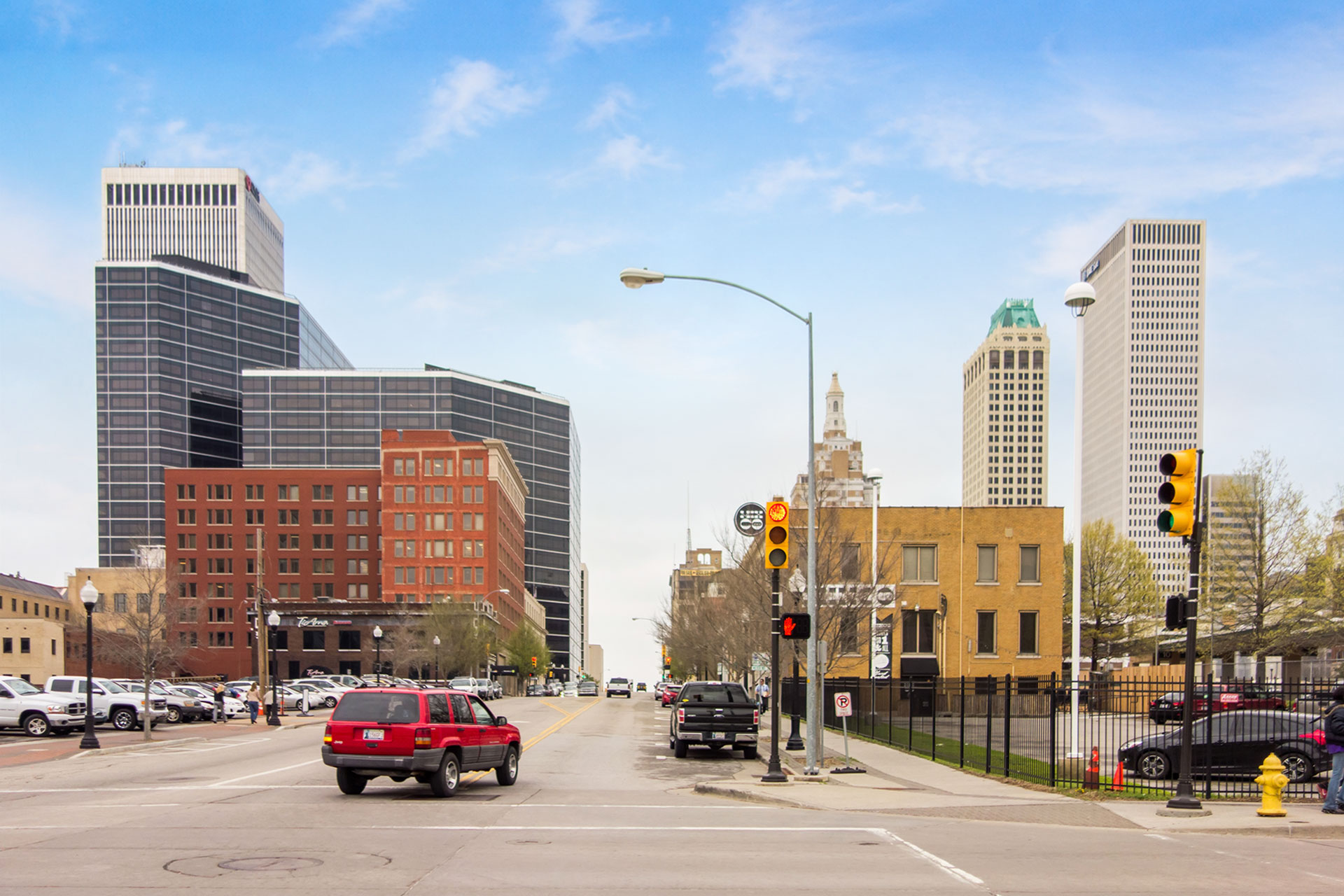 Downtown Tulsa street scene with vehicles representing Oklahoma vehicle tag renewal and registration services
